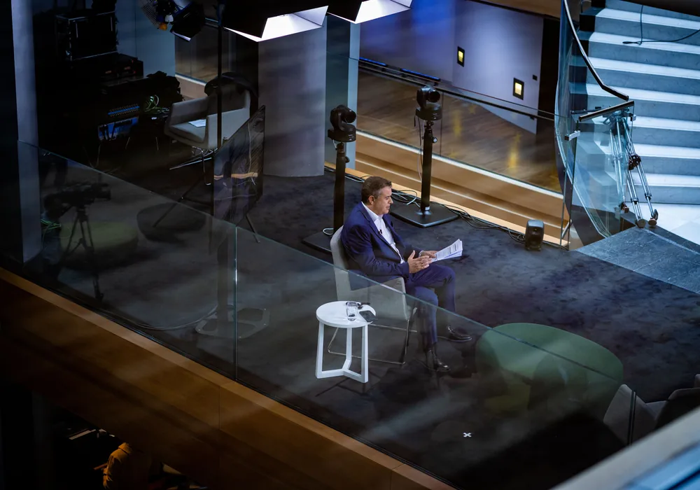 Executive being interviewed on camera in a broadcast studio