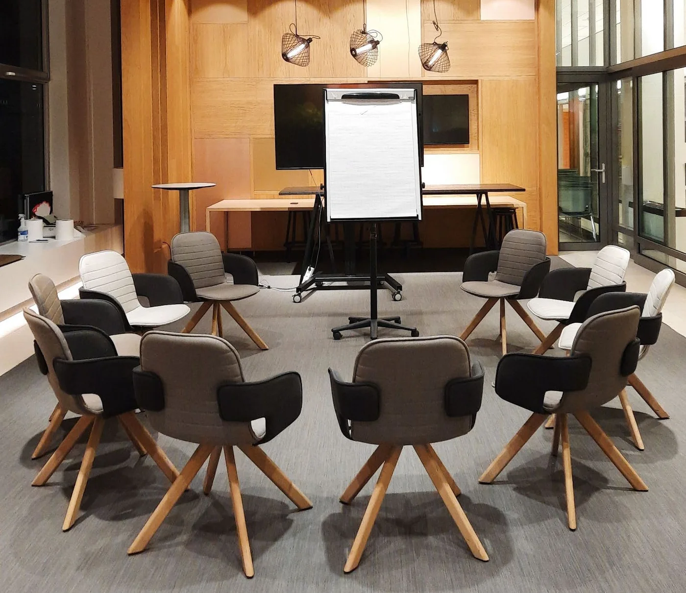 Empty circle of chairs around a flip chart